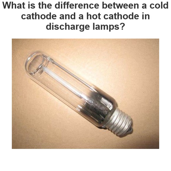 What is the difference between a cold cathode and a hot cathode in discharge lamps?